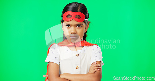 Image of Angry, crossed arms and face of child on green screen with upset, disappointed and anger expression. Portrait, mockup studio and young girl in superhero costumer with mad, unhappy and shake head