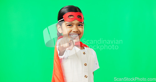 Image of Superhero, point and face of child on green screen for fantasy, cosplay costume and comic character. Choose gesture, hero mockup and portrait of girl in studio for freedom, fight crime and games