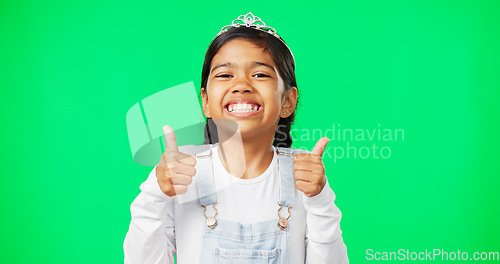 Image of Portrait, children and thumbs up with a girl on a green screen background in studio wearing a princess tiara. Kids, thank you and emoji with an adorable little girl child saying yes in agreement