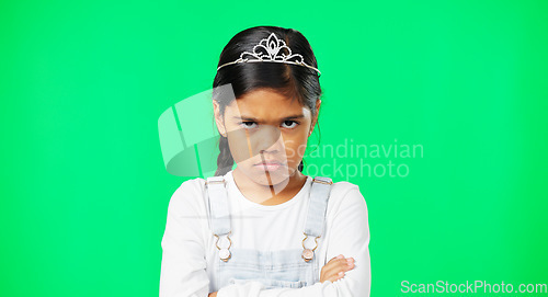 Image of Angry, upset and child with crossed arms on green screen with crown, princess costume and tutu in studio. Portrait, behavior mockup and isolated young girl with anger, disappointed and mad expression