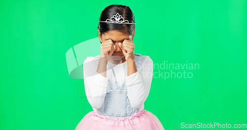Image of Sad, depression and child crying on green screen with crown, princess costume and tutu in studio. Sadness mockup, tears and isolated young girl with worried, upset and disappointed facial expression