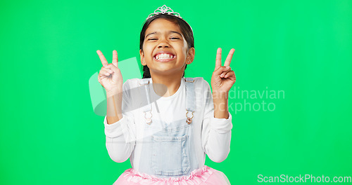 Image of Peace, fun and hand gesture with a girl on a green screen background in studio feeling silly or carefree. Portrait, dance and emoji with an adorable little female child looking goofy or playful