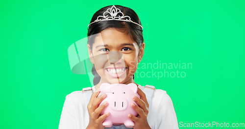 Image of Girl, piggy bank and face with smile in studio by green screen for saving mockup, money or princess aesthetic. Happy young female, royal and fairytale portrait with cash, tiara and finance mock up