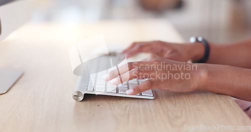 Image of Closeup of a businesswoman browsing on a computer keyboard against a white background. Hands of a productive entrepreneur typing emails and compiling online reports while doing research and planning