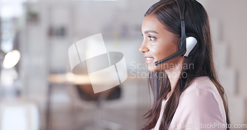 Image of Call center or customer support agent talking to a client using headphones while sitting and working inside. Remote worker offering great service, advice and explaining a product or insurance plan