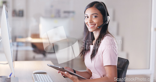 Image of Portrait of a young female customer service agent working in ecommerce and sales. Business woman working on a tablet in her office while helping and assisting customers online with IT support