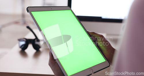 Image of Close up of an African American persons hands holding a tablet with a plain green screen with a blurred background of headphones. Technician working out how to fix broken device. IT problem solving
