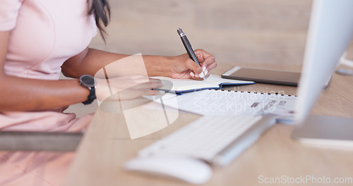 Image of Office woman working on a schedule or online appointments and making notes in her calendar diary. One young professional therapist planning, checking and filing information on desktop computer