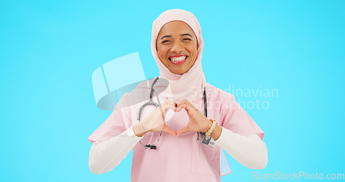Image of Face, nurse and Muslim woman with heart hands in studio isolated on a blue background mockup. Smile, portrait and happy medical professional or Islamic person with emoji or symbol for love and care.