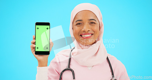 Image of Green screen, phone and nurse isolated on blue background with medical mobile app, tracking marker and healthcare mockup. Happy islamic doctor or woman face with cellphone product placement in studio