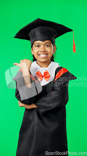Image of Graduation, education and child point on green screen for graduate, back to school deal and announcement. Mockup, student and portrait of young girl with knowledge, achievement and smile in studio