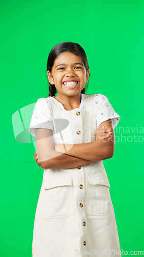 Image of Happy, face and child in studio with green screen standing with crossed arms for confidence. Happiness, smile and portrait of girl kid model with cute and adorable expression by chroma key background