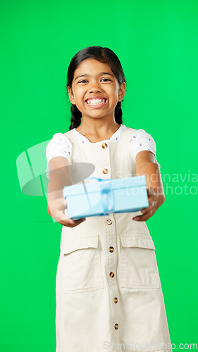 Image of Girl child, box and gift by green screen studio in with smile, happiness or giving mockup for kindness. Kid, vertical portrait and present package on holiday, birthday party or happy childhood memory