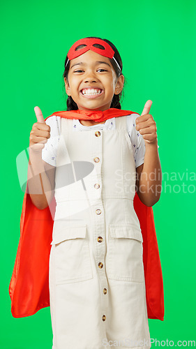 Image of Little girl, superhero and thumbs up on green screen for success against a studio background. Portrait of happy adorable child or kid in hero cosplay showing thumb emoji, yes sign or like on mockup