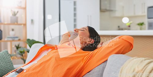 Image of Woman, relax and hands behind head on sofa, living room and lounge for happiness, calm mind and easy lifestyle at home. Happy young female in peace on couch, smile and zen mental health for self care