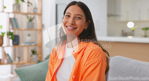 Image of Face, happy and woman on couch, relax and positive in living room, carefree and resting. Portrait, American female and lady on sofa, smile and stress relief in lounge, girl with happiness or cheerful