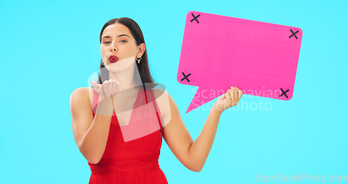 Image of Speech bubble, face and woman blowing kiss in studio for romance, flirting and poster on blue background. Banner, portrait and girl flirt with mockup for social media, advertising or online dating