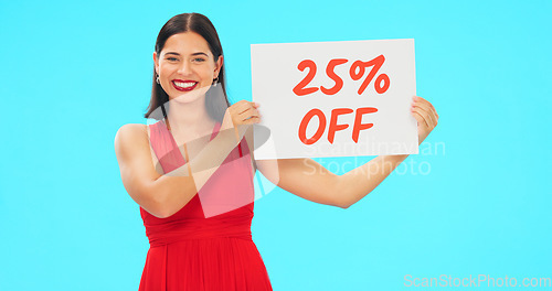 Image of Woman, portrait and sale sign for studio advertising percentage or discount rate on paper or banner. Smile of a happy female on a blue background for fashion promotion deal, savings or deal and offer