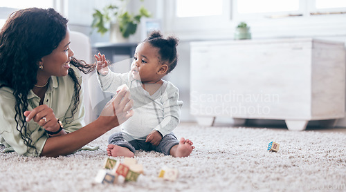 Image of Black baby, mother and toy letter blocks for language development on living room floor. Family home, teaching and mom with girl toddler learning with happiness and a smile with love and mockup