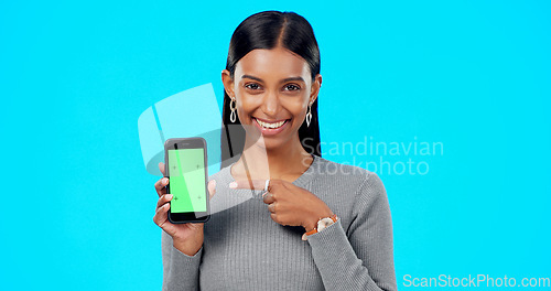 Image of Woman, pointing and phone green screen mockup with a smile and hand for advertising website space. Face of indian female model with smartphone for branding app, logo or ux while happy and excited