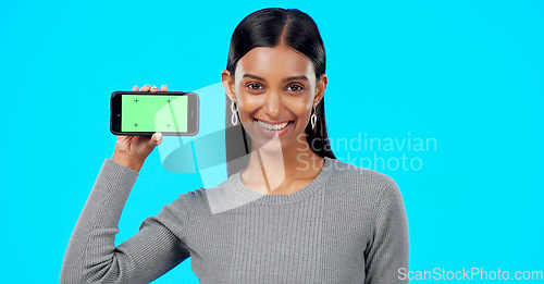 Image of Woman, happy and phone green screen mockup with a smile for advertising website space. Face portrait of indian female model show smartphone for branding app, logo promotion or ux while excited