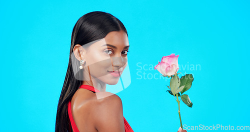 Image of Studio face, flower and beauty woman with nature plant, sustainable agriculture portrait and natural organic product. Eco friendly makeup, floral plant and skincare person portrait on blue background