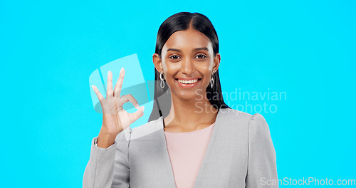 Image of Perfect, satisfied and businesswoman with ok hand gesture, sign or symbol feeling happy isolated in studio blue background. Smile, excited and portrait of satisfied female showing yes and approval