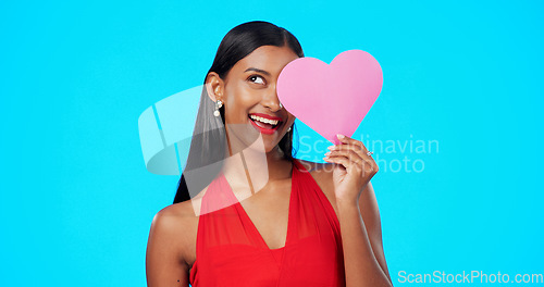 Image of Thinking, happy or woman with heart paper sign for Valentines Day, studio care and emoji love icon, symbol or poster. Portrait, female beauty or person contemplating secret admirer on blue background