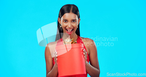 Image of Gift box, retail and happy studio woman with sales product, discount birthday deal or Valentines Day present. Commerce market portrait, store container and luxury person isolated on blue background