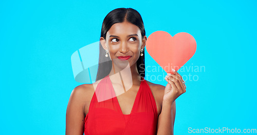 Image of Thinking, happy or woman with heart paper sign for Valentines Day, studio care and emoji love icon, symbol or poster. Portrait, female beauty or person contemplating secret admirer on blue background