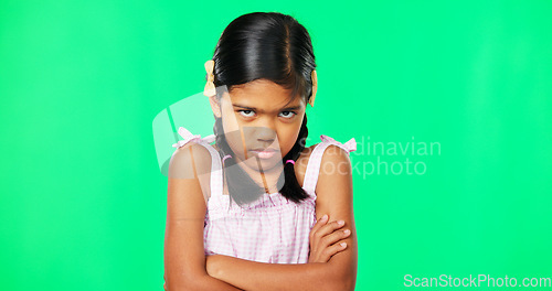 Image of Angry, crossed arms and face of child on green screen with upset, disappointed and anger expression. Emoji, mockup studio and portrait of isolated young girl mad, unhappy and shake head for problem