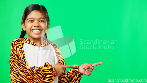 Image of Mockup, pointing and face of a child on a green screen isolated on a studio background. Laughing, branding and portrait of a girl gesturing to space for a logo, marketing or product placement