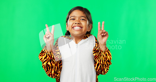 Image of Happy, dance and peace sign with girl in studio for kindness, positive and pride. Happiness, support and gesture with young child isolated on green background for cheerful, carefree and confidence