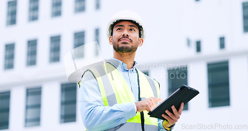 Image of Thinking architect browsing digital tablet, analysing building plans for city planning, residential or office development. Architectural engineer or contractor checking online blueprint on technology