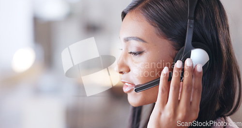 Image of Call center agent helping client in a phone call giving great customer service. Customer support employee consulting clients online using headset. Professional friendly woman working at her desk