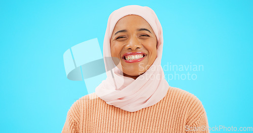 Image of Muslim woman, laugh and happy portrait with a scarf for mockup, advertising or joke. Islamic female model with makeup and hijab laughing for comic emoji, funny meme or fashion on blue background