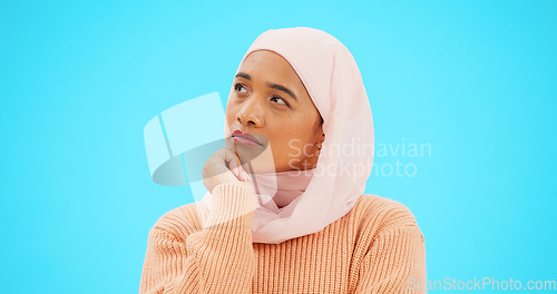 Image of Muslim woman, thinking and idea with hand on face for mockup, advertising or thought. Serious islamic female with hijab and emoji for doubt, sad and to think about option on a studio blue background