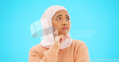 Image of Muslim woman, thinking and idea with hand on face for mockup, advertising or thought. Serious islamic female with hijab and emoji for doubt, sad and to think about option on a studio blue background