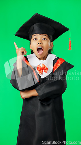 Image of Graduation, surprise and child point on green screen for graduate, academy ceremony and award. Primary school, education and portrait of shocked girl with knowledge, achievement and success in studio