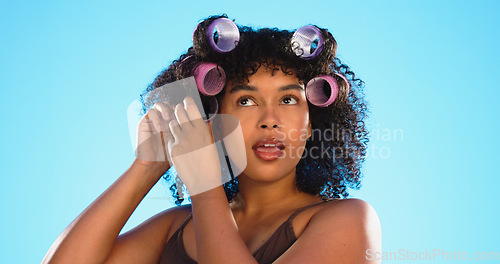 Image of Black woman, hairstyle curlers and studio background with smile for beauty, self care and natural aesthetic. Happy gen z model, african girl and natural hair with happiness, plastic mould and soft