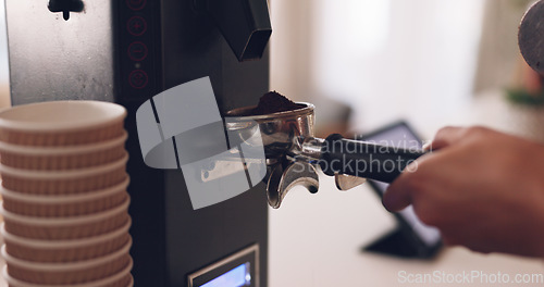 Image of Coffee machine, barista hand and grind beans in cafe, closeup and prepare latte or espresso drink with service. Hot beverage, person working in restaurant and brewing process, premium blend caffeine