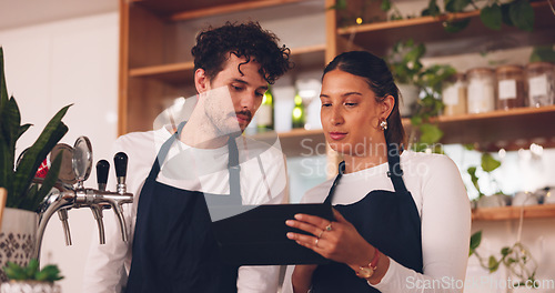 Image of Barista team, talking with tablet in coffee shop, man and woman, discussion about work schedule or inventory check. Communication, technology with online system in cafe, working and manage sales