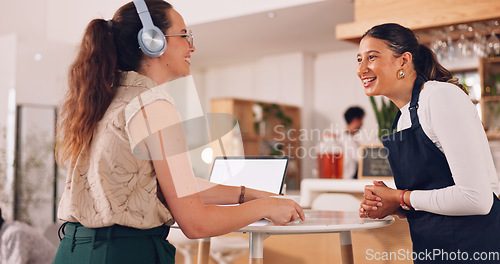 Image of Barista helping customer, woman giving order to barista. Smiling customer getting coffee.