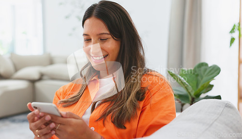 Image of Woman, phone and laughing for funny joke, meme or social media post relaxing on living room sofa at home. Happy female chatting, texting and laugh on smartphone for fun online communication on couch