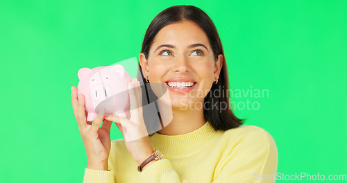 Image of Happy woman, face and money savings on green screen for investment, budget or finance against studio background. Portrait of excited female holding piggybank for coin, profit or investing on mockup