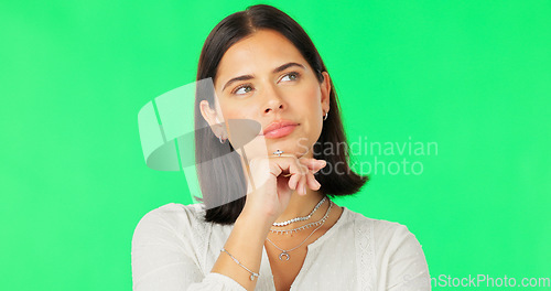 Image of Face, idea and decision with a woman on a green screen background in studio to consider an option. Thinking, mind and contemplating with an attractive young female looking thoughtful on chromakey