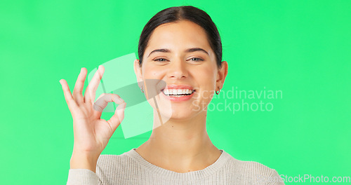 Image of Face, green screen and woman with ok sign, smile and approval against a studio background. Portrait, female and person with symbol for perfect, hand gesture for support and motivation with happiness