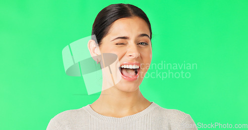 Image of Happy, woman and winking face on green screen, studio and color background. Portrait, female model and smile for wink, secret and cool girl in fun mood, personality and happiness for flirting emoji