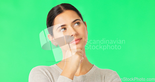 Image of Face, idea and option with a woman on a green screen background in studio to consider a decision. Thinking, mind and contemplating with an attractive young female looking thoughtful on chromakey