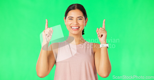 Image of Happy laugh, woman face and pointing up to show promotion and product placement in green screen. Happiness, smile and model gesture to advertising and commercial deal in isolated studio background